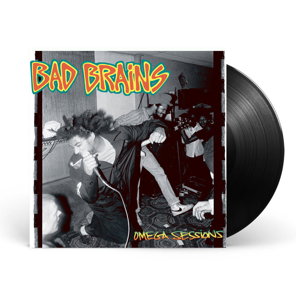  Image of a vinyl sleeve and black vinyl against a white background. The vinyl sleeve features a photo of the bad brains omega sessions album artwork. The artwork is a black and white image of the band performing. The singer and guitar player are shown with some fans in the background. The top left of the image says Bad Brains in red lettering and is outlined in yellow and then again in green. The bottom right of the image says omega session in a green, yellow, orange gradient color.