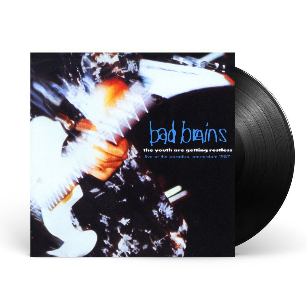Photo of the bad brains the youth are getting restless (live at the paradise, amsterdam 1987) vinyl sleeve and black vinyl. The album artwork on the sleeve is a close up photo of someone playing a guitar, you see their hand and the guitar. The image has a faded and blurred effect to it. The right side of the album artwork says bad brains in blue. Below that in white text says The youth are getting restless. Below that in blue text says live at the paradise, amsterdam 1987.
