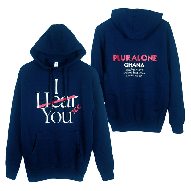 image of the front and back of a navy pullover hoodie on a white background. front is on the left and has a center chest print that says I hear you with hear scratched out and see written next to it. the back is on the right and says pluralone ohana with the dates of their fest