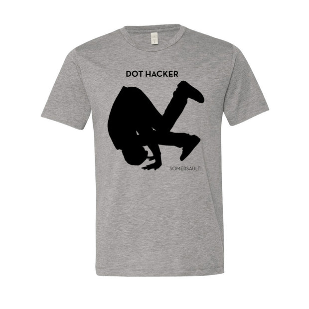 image of a heather grey tee shirt on a white background. tee has center chest print in black of a silhouetted man doing a somersault. the top says dot hacker